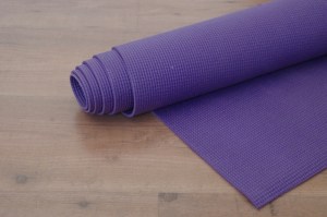 yoga-mat-on-wooden-floor