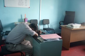 man sleeping at desk